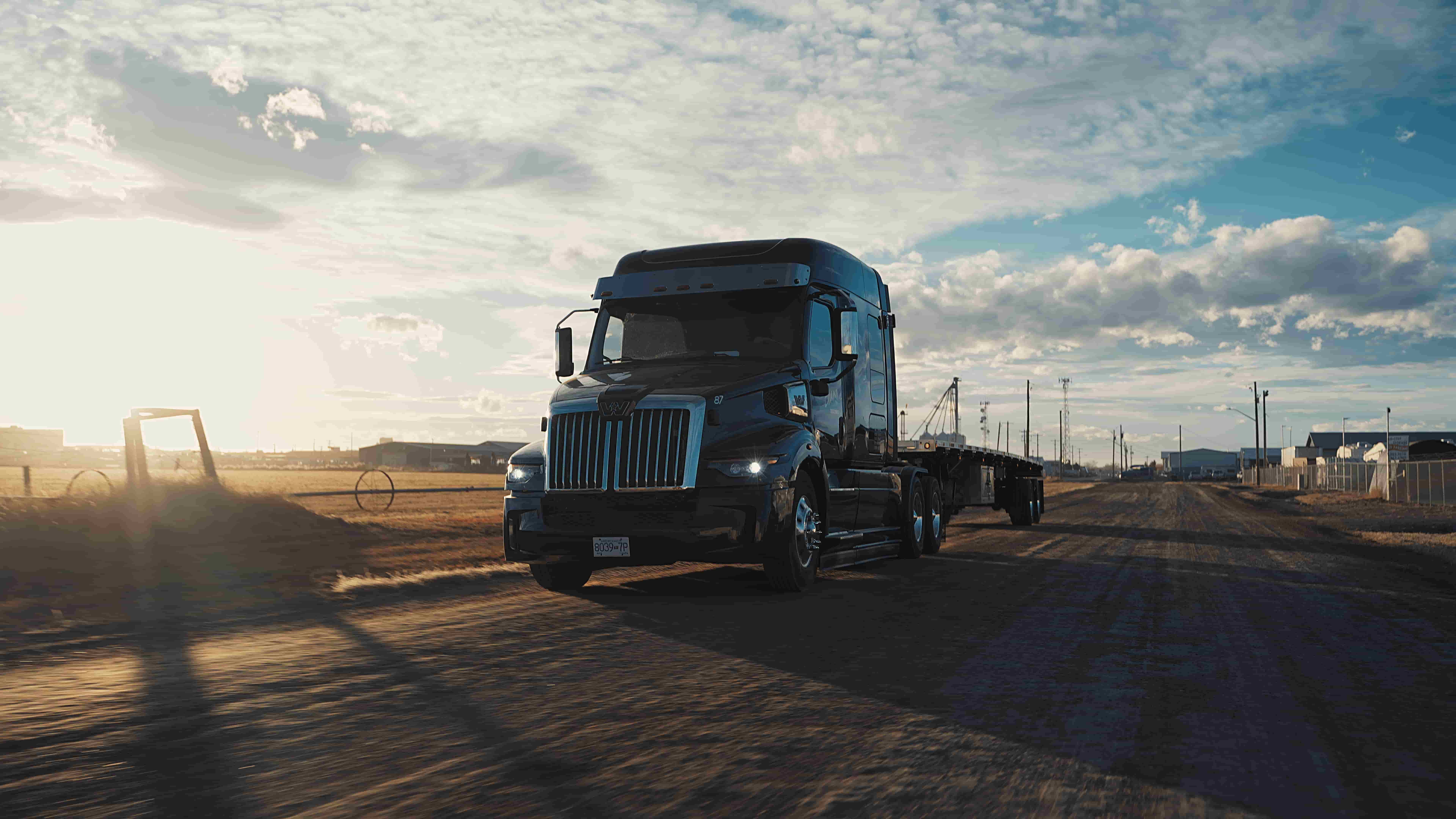 Truck driving in the sunset